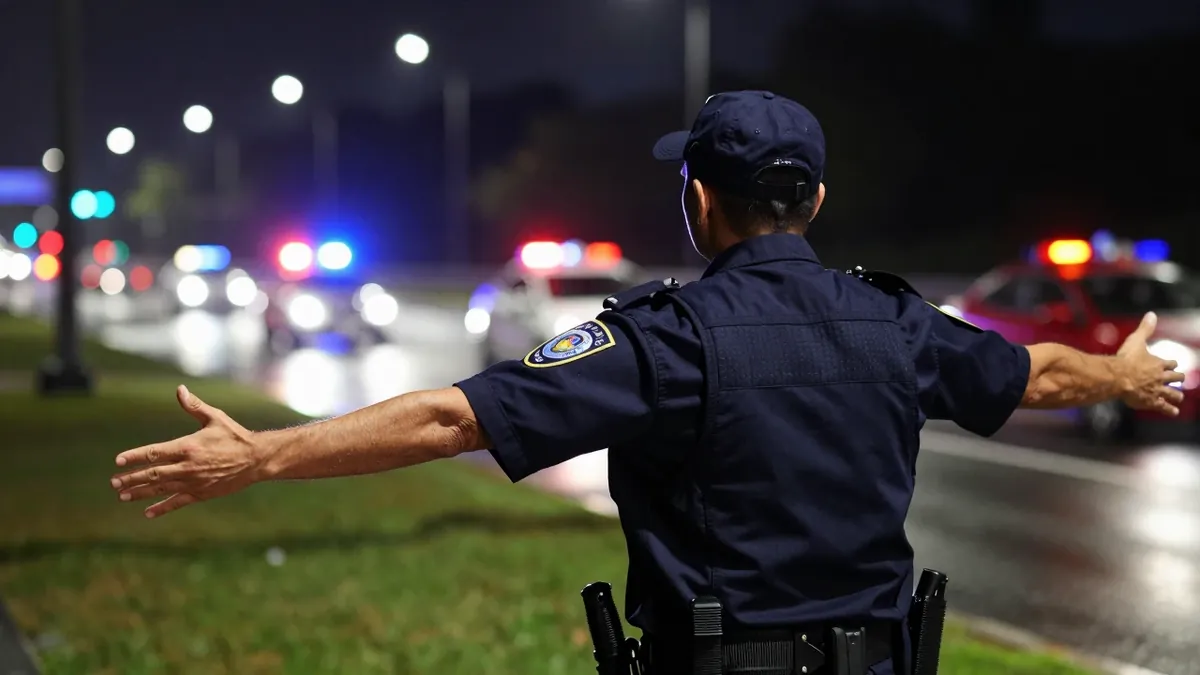 A Garda in his 30s was hospitalized in serious condition after falling from a moving police van following a Bohemians...